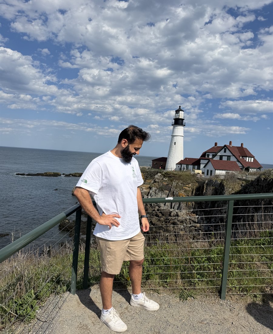 Mushtaq Alzuhairi near a coastal lighthouse